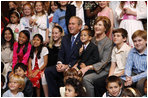 President George W. Bush and Mrs. Laura Bush sit for a photo with the children of U.S. Embassy staff Sunday, Nov. 23, 2008, in Lima. Peru.