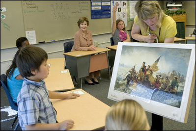 Mrs. Laura Bush watches during a visit to the fourth-grade classroom of Susan Weekes at the Riverside Elementary School in Bismarck, N.D., Thursday, Oct. 2, 2008, as Ms. Weekes shows students a painting by Emanuel Leutze of General George Washington crossing the Delaware River. The First Lady was visiting the school to highlight the National Endowment for the Humanities ' Picturing America' program which provides iconic artwork and photography for students to study.
