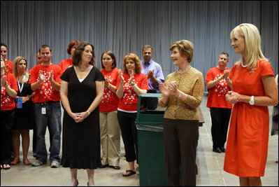 Mrs. Laura Bush and Mrs. Cindy McCain applaud the efforts of volunteers who are setting up a space in Minneapolis Convention Center Monday, September 1, 2008, to assemble and ship out care kits to support the victims of Hurricane Gustav.