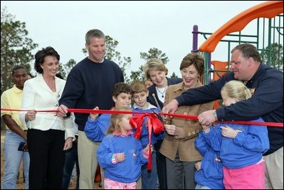 Laura Bush attends a ribbon cutting ceremony with football star Brett Favre and his wife, Deanna, left, Secretary Margaret Spelling, center, Darell Hammond, Associate Director, USA Fredom Corps, right, and student of Hancock North Central Elementary Shool at the Kaboom Playground, built at the Hancock North Central Elementary School in Kiln, Ms., Wednesday, Jan. 26, 2006, during a visit to the area ravaged by Hurricane Katrina.