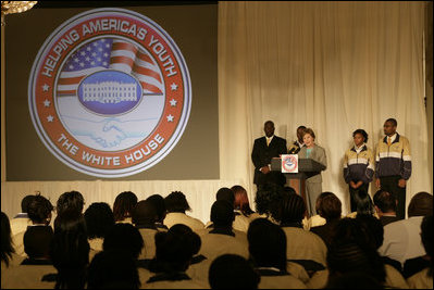 Mrs. Laura Bush is joined on stage by Ballou High School Marching Band Director Darrell Watson, left, band members Lewis Franklin, Rhia Hardman and Kenneth Horne, right, as she addresses students and guests at the White House Thursday, Oct. 11, 2007, prior to a screening of Ballou: A Documentary Film, about the Washington, D.C. band’s inspiring accomplishments. Mrs. Bush said, “Mr. Darrell Watson epitomizes the core message of the Helping America’s Youth initiative-that caring adults can have a powerful impact on the lives of our nation’s youth.”