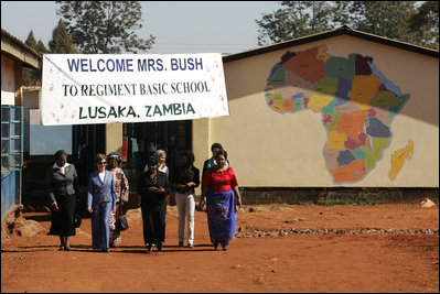 Mrs. Laura Bush and her daughter, Ms. Jenna Bush, visited Senegal, Mozambique, Zambia, and Mali to promote The President’s Malaria Initiative, the President’s Emergency Plan for AIDS Relief (PEPFAR), and President Bush’s Africa Education Initiative. In this photo, Mrs. Laura Bush and Ms. Jenna Bush visit Regiment Basic School with First Lady Mrs. Maureen Mwanawasa and her daughter Chipo Mwanawasa Thursday, June 28, 2007, in Lusaka, Zambia.