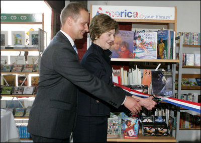 Mrs. Laura Bush participates in a ribbon cutting, assisted by Michael Gawenda, director of the City Library of Stralsund, Thursday, July 13, 2006, at the Stralsund Children's Library in Stralsund, Germany, to open the exhibit America@yourlibrary. The America@yourlibrary is a new initiative to develop existing and new partnerships between German public libraries and the U.S. Embassy and Consulate Resource Centers. 