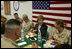 Laura Bush laughs with troops as they eat dinner in the Dragon Chow Dining Hall at Bagram Air Base in Kabul, Afghanistan, Wednesday, March 30, 2005. 