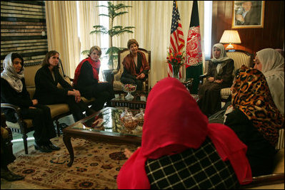 Laura Bush and Dr. Zenat Karzai, wife of President Hamid Karzai, U. S. Secretary of Education Margaret Spellings, second left, and Under Secretary of State for Global Affairs Paul Dobrianski, left, talk with Afghan women about issues of women's rights and education at the presidential residence in Kabul, Afghanistan Wednesday, March 30, 2005. 