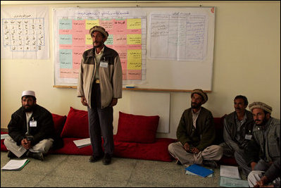 A man studying to be a teacher stands to introduce himself during a visit by Mrs. Bush to Kabul University in Kabul, Afghanistan, Wednesday, March 30, 2005. 