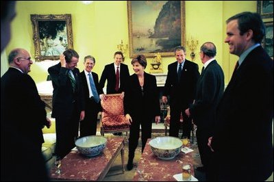 President George W. Bush and Laura Bush share a light moment with British Prime Minister Tony Blair and their staffs during a visit to the White House Friday, January 31, 2003. White House photo by Eric Draper.