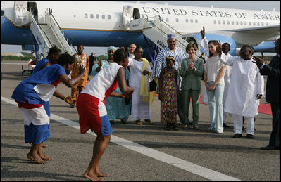 Mrs. Laura Bush and her daughter Barbara Bush are greeted by a cultural dance troupe upon their arrival Sunday, Jan. 15, 2006 at Kotoka International Airport in Accra, Ghana. White House photo by Shealah Craighead