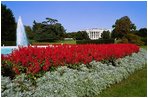 The South Grounds Fountain is encircled by Salvia (Red Flare) and Dusty Miller during the 2004 fall garden season at the White House.