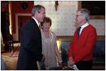 President George W. Bush greets Fred Rogers of Mister Rogers Neighborhood in the Blue Room before an early childhood education event in the East Room April 3, 2002. 