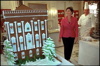 In the China Room on December 2, 2001, Laura Bush takes a sneak preview at White House Pastry Chef Roland Mesnier's gingerbread creation. Built from more than 80 pounds of gingerbread, it was a re-creation of the original White House as it appeared in 1800 when John Adams became the first resident.