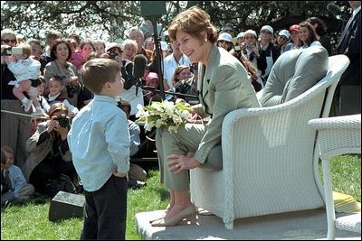Laura Bush takes a moment for a little reader during one of the many story book hours at the annual White House Easter Egg Roll on the South Lawn of the White House April 1, 2002. Several cabinet secretaries, such as Rod Paige and Norman Mineta, gave readings. Marc Brown, who wrote the children's book 