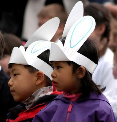 Listening to stories told by authors and Cabinet Secretaries, two young children perk their ears up during story time at the White House Easter Egg Roll Monday, April 21, 2003. 