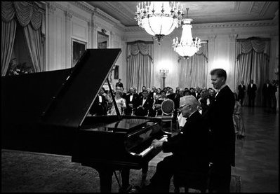 Former President Harry Truman tickles the ivories for President and Mrs. Kennedy in the East Room November 1, 1961.