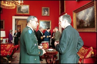 President George H.W. Bush talks with General Colin Powell, during a meeting with the Joint Chiefs of Staff in the Red Room on January 16, 1992. General Powell later served as Secretary of State during President George W. Bush's first term.