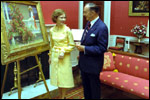 Rosalynn Carter admires a painting in the Red Room with White House Curator Clem Conger September 28, 1977.