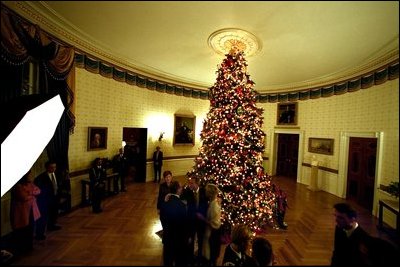 The President and Mrs. Bush greet their guests before posing for a picture in front of the White House Christmas tree.