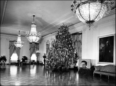 The silver-tinseled 1954 Eisenhower Tree was the sight of busy activity for the President's family. The Eisenhower grandchildren enjoyed the excitement of opening their presents under this beautiful tree.