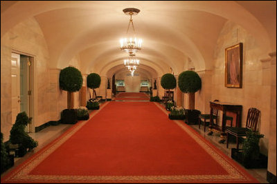 Topiary trees line the hallway of the Ground Floor of the White House residence.