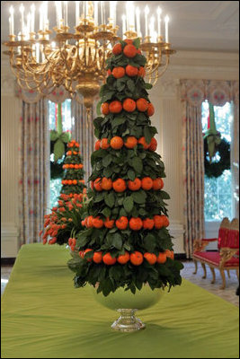 Two topiaries of lemon leaves and tangerines stand tall in the State Dining Room.