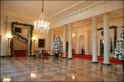 The North Portico of the White House opens up to the Cross Hall lined in fresh Boxwood Garland.