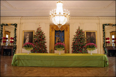 Christmas Trees in the East Room are decorated with roses as the traditional scene of the creche is featured prominently.