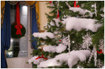 Crystal ornaments, red ribbons and make-believe snow decorate the official White House Christmas tree in the Blue Room of the White House, Wednesday, Nov. 29, 2006, an 18-foot Douglas fir tree donated by the Crystal Springs Tree Farm of Lehighton, Pa. 