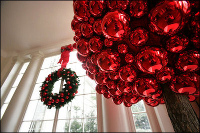 Festive wreaths are hung in each of the windows along the East Colonnade, where red ornament balls create bold tree-like sculptures.