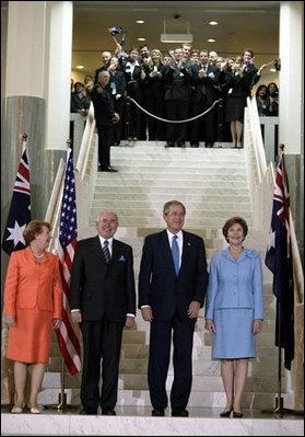 President George W. Bush and Laura Bush stand with Australian Prime Minister John Howard and his wife Jannette Howard at the Parliament House in Canberra, Australia, Oct. 23, 2003. White House photo by Paul Morse