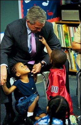 During a tour of Highland Park Elementary School in Landover, Md., President Bush plays with children at the school's Head Start Center where he discussed strengthening America's Head Start Program Monday, July 7, 2003.