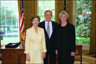 President George W. Bush and Laura Bush congratulate 2003 Maine Teacher of the Year Patricia R. Perry in the Oval Office Wednesday, April 30, 2003. White House Photo by Eric Draper