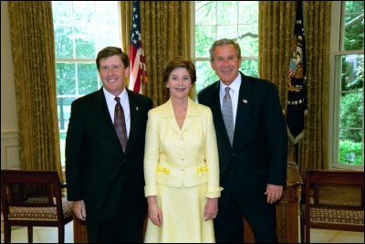 President George W. Bush and Laura Bush congratulate 2003 Maine Teacher of the Year Robert D. Grimm in the Oval Office Wednesday, April 30, 2003. White House Photo by Eric Draper