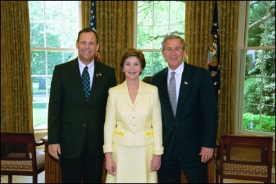 President George W. Bush and Laura Bush congratulate 2003 Maine Teacher of the Year Robert W. Pickett in the Oval Office Wednesday, April 30, 2003. White House Photo by Eric Draper