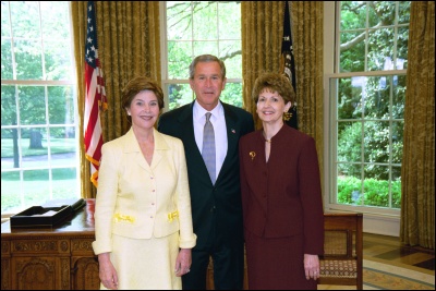 President George W. Bush and Laura Bush congratulate 2003 Maine Teacher of the Year Diana Buter in the Oval Office Wednesday, April 30, 2003. White House Photo by Eric Draper