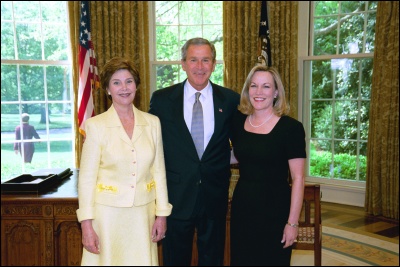 President George W. Bush and Laura Bush congratulate 2003 Maine Teacher of the Year Ruth Ann Gharst in the Oval Office Wednesday, April 30, 2003. White House Photo by Eric Draper