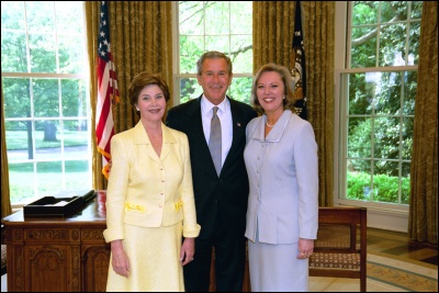 President George W. Bush and Laura Bush congratulate 2003 Maine Teacher of the Year Patrice P. McCrary in the Oval Office Wednesday, April 30, 2003. White House Photo by Eric Draper