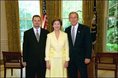 President George W. Bush and Laura Bush congratulate 2003 Maine Teacher of the Year Darren Ray Hornbeck in the Oval Office Wednesday, April 30, 2003. White House Photo by Eric Draper