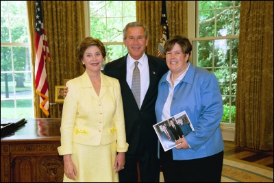 President George W. Bush and Laura Bush congratulate 2003 Maine Teacher of the Year Susan L. Gutierrez in the Oval Office Wednesday, April 30, 2003. White House Photo by Eric Draper