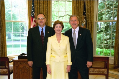 President George W. Bush and Laura Bush congratulate 2003 Maine Teacher of the Year Paul M. Cuicchi in the Oval Office Wednesday, April 30, 2003. White House Photo by Eric Draper
