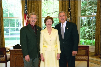 President George W. Bush and Laura Bush congratulate 2003 Maine Teacher of the Year Jon Dean in the Oval Office Wednesday, April 30, 2003. White House Photo by Eric Draper
