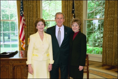 President George W. Bush and Laura Bush congratulate 2003 Maine Teacher of the Year Suzanne Ratzlaff in the Oval Office Wednesday, April 30, 2003. White House Photo by Eric Draper