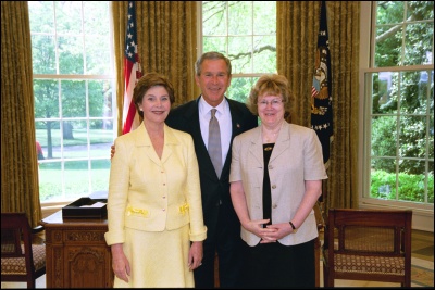 President George W. Bush and Laura Bush congratulate 2003 Maine Teacher of the Year Sharon Crossen in the Oval Office Wednesday, April 30, 2003. White House Photo by Eric Draper