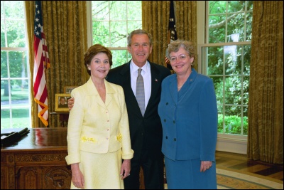 President George W. Bush and Laura Bush congratulate 2003 Maine Teacher of the Year Elspeth Corrigan Moore in the Oval Office Wednesday, April 30, 2003. White House Photo by Eric Draper