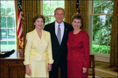 President George W. Bush and Laura Bush congratulate 2003 Maine Teacher of the Year Carol Rossi-Fries in the Oval Office Wednesday, April 30, 2003. White House Photo by Eric Draper