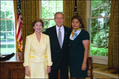 President George W. Bush and Laura Bush congratulate 2003 Commonwealth of the Northern Mariana Islands Teacher of the Year Bertha Leon Guerrero in the Oval Office Wednesday, April 30, 2003. White House Photo by Eric Draper