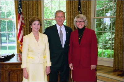 President George W. Bush and Laura Bush congratulate 2003 Maine Teacher of the Year Melissa Ellis Bartlett in the Oval Office Wednesday, April 30, 2003. White House Photo by Eric Draper