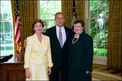 President George W. Bush and Laura Bush congratulate 2003 Maine Teacher of the Year Joyce Dunn in the Oval Office Wednesday, April 30, 2003. White House Photo by Eric Draper