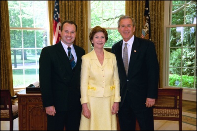 President George W. Bush and Laura Bush congratulate 2003 Maine Teacher of the Year Charles L. Boucher in the Oval Office Wednesday, April 30, 2003. White House Photo by Eric Draper