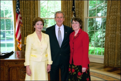 President George W. Bush and Laura Bush congratulate 2003 Maine Teacher of the Year Kathleen Jacob in the Oval Office Wednesday, April 30, 2003. White House Photo by Eric Draper