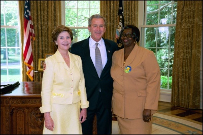 President George W. Bush and Laura Bush congratulate 2003 Virgin Islands Teacher of the Year Annette Kelly in the Oval Office Wednesday, April 30, 2003. White House Photo by Eric Draper
